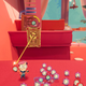 A young man holds a red, tiny alien with a lit fuse on its head and aims it at a breakable box.